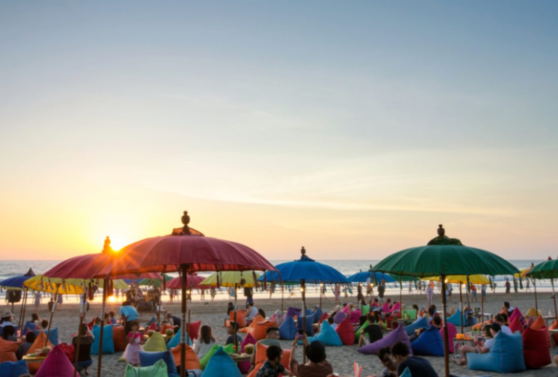 Sunset over beach diners on Seminyak Beach, Bali