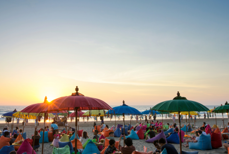 Sunset over beach diners on Seminyak Beach, Bali