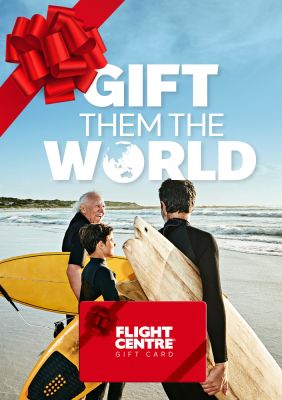 Gift them the world - flight centre. Grandfather, father and son on a beach ready to go surfing