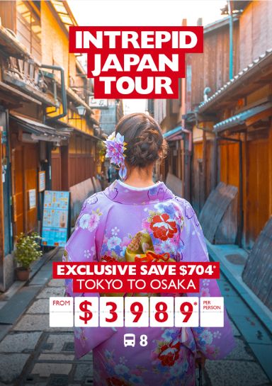 Intrepid Japan tour - Exclusive save $704* | Tokyo to Osaka from $3,989* per person. Woman in a pink kimono walking down a thin street in Kyoto