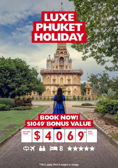 Luxe Phuket holiday | book now! $1,049 bonus value | return from $4,069 for two. Woman in a blue dress walking towards a tall temple in Phuket