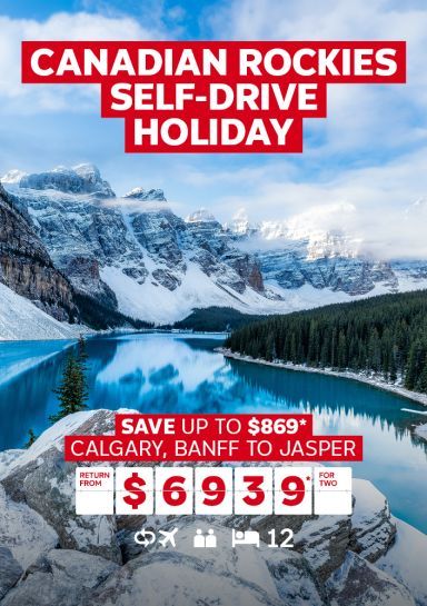 Canadian Rockies self-drive holiday | save up to $869* - Calgary, Banff to Jasper. Return from $6,939* for two. Wide shot of nature in Canada; snowy mountains, pine forests and a clear lake