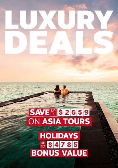 luxury deals over image of couple in pool overlooking ocean