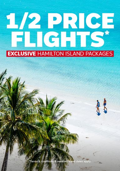 1/2 Price Flights* - Exclusive Hamilton Island packages. Couple walking on a white beach