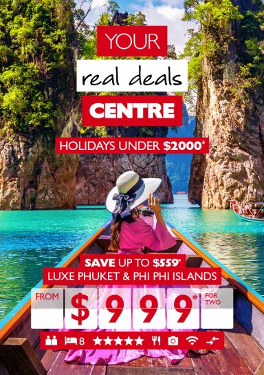 Your real deals centre - holidays under $2,000*. Save up to $559* | Luxe Phuket & Phi Phi Islands from $999* for two. Person wearing a bright pink maxi dress looking at rocky formations from a rowboat