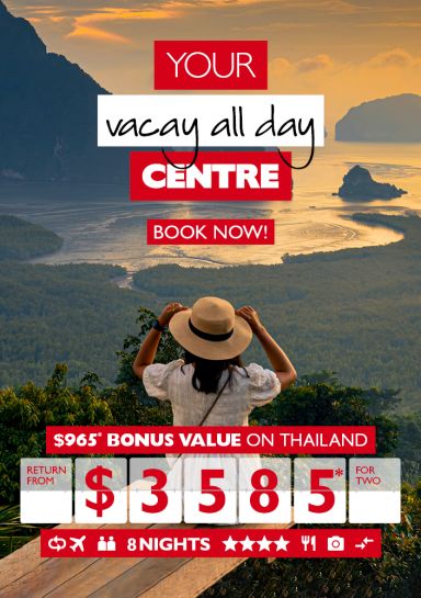 Your vacay all day centre - book now! $965* bonus value on Thailand return from $3,585* for two. Woman holding her hat looking out at a bay in Thailand