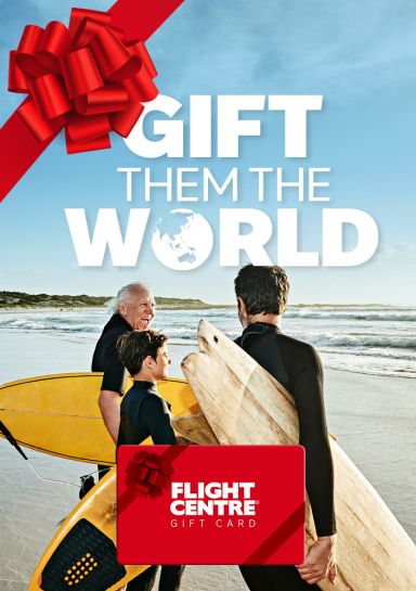 Gift them the world - flight centre. Grandfather, father and son on a beach ready to go surfing
