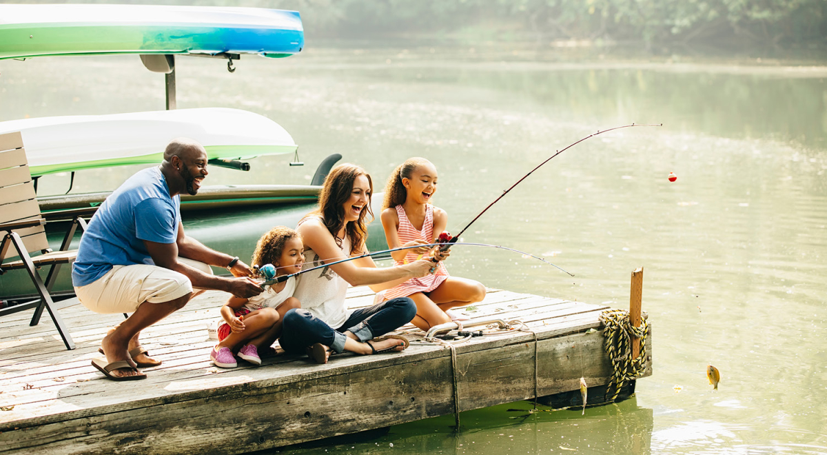A family casually fishing from a dock while on vacation