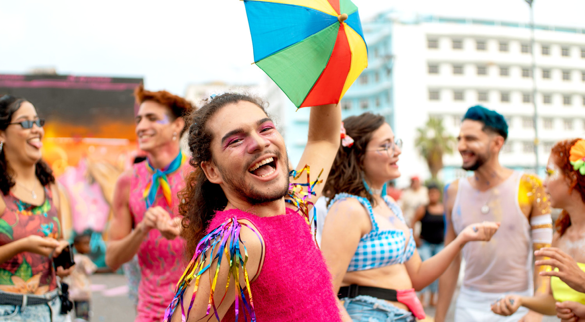 People dressed in colourful outfits for a Pride celebration