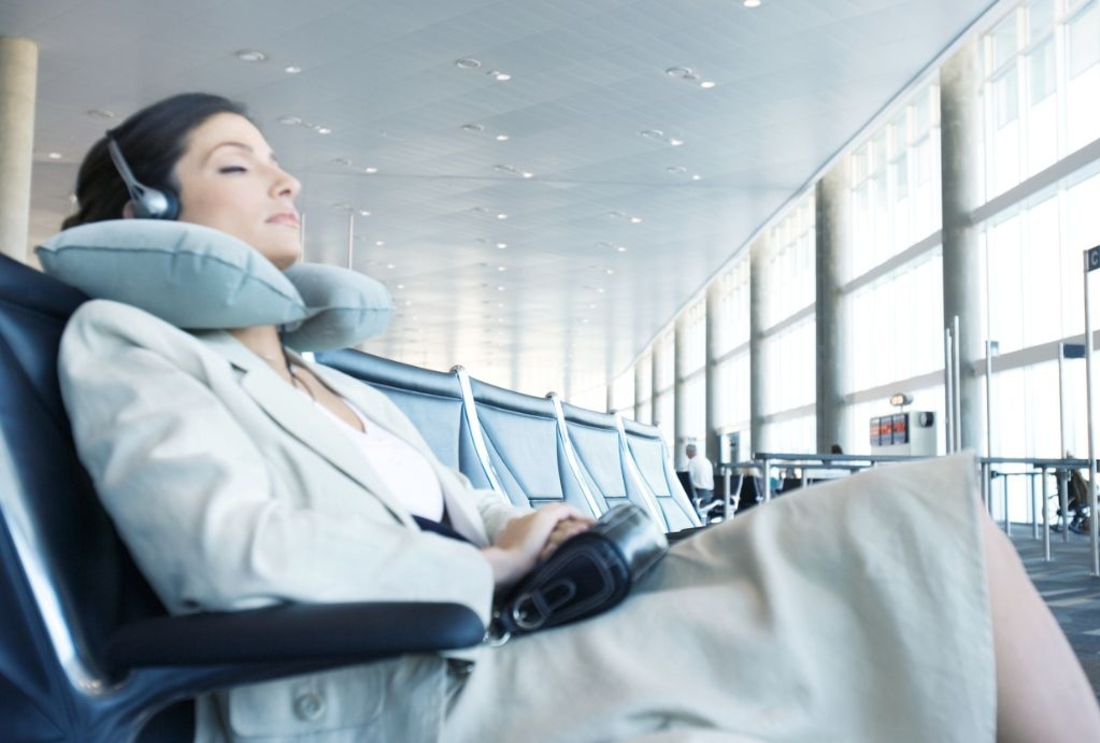 Image of a person in an airport with a travel pillow