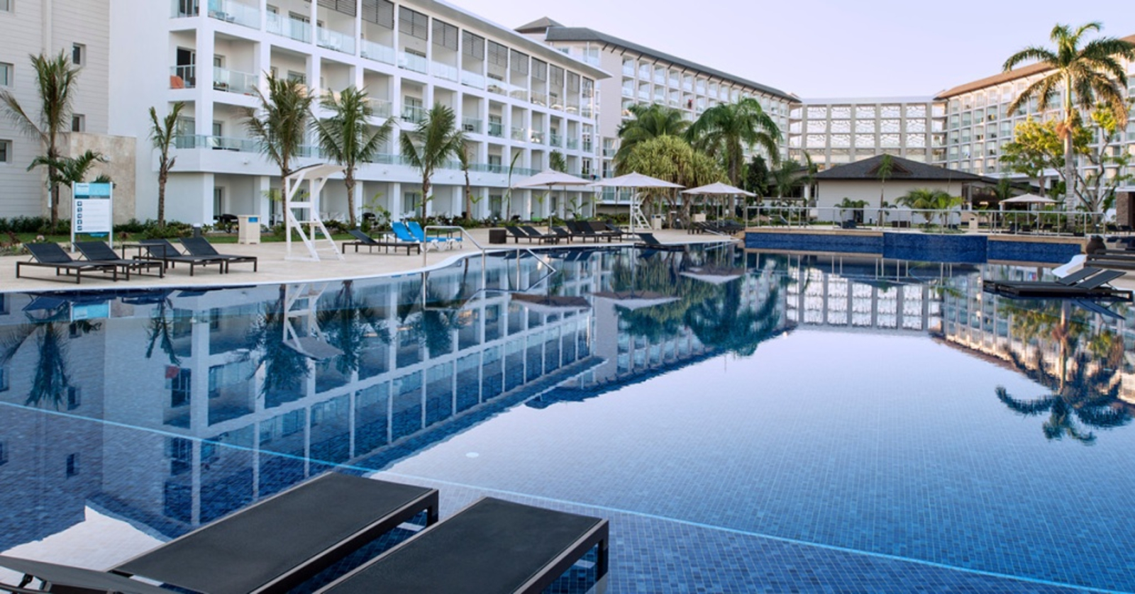 Royalton White Sands hotel in Jamaica - large white hotel with a dark blue pool