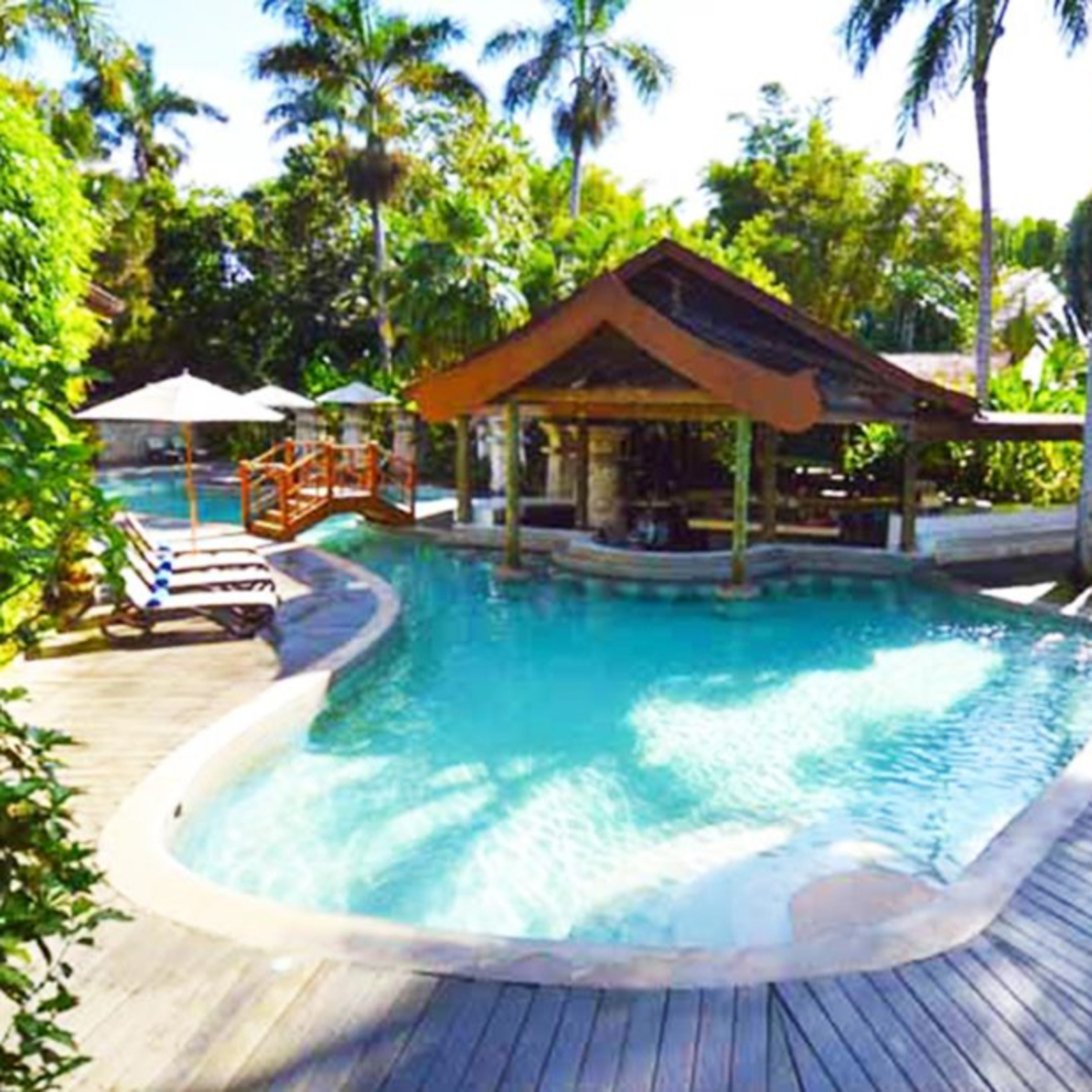 sunny hotel pool with swim-up bar