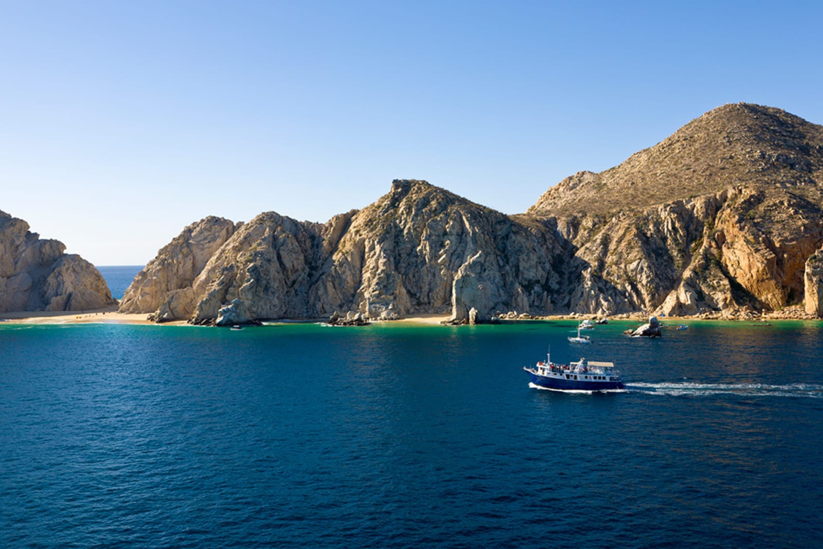 Boats approaching Lover's Beach in Cabo San Lucas