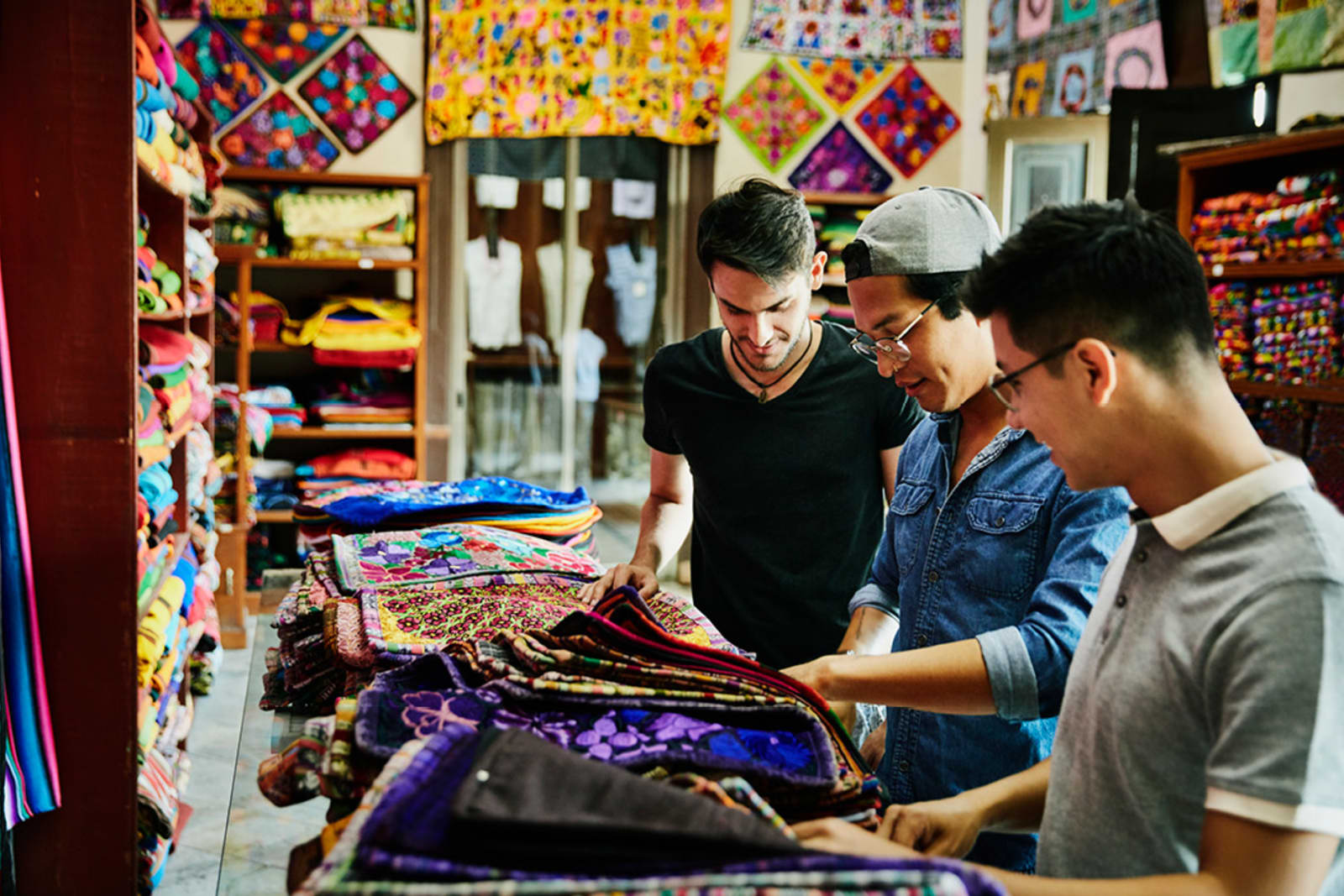 Group of people shopping for textiles at a local market