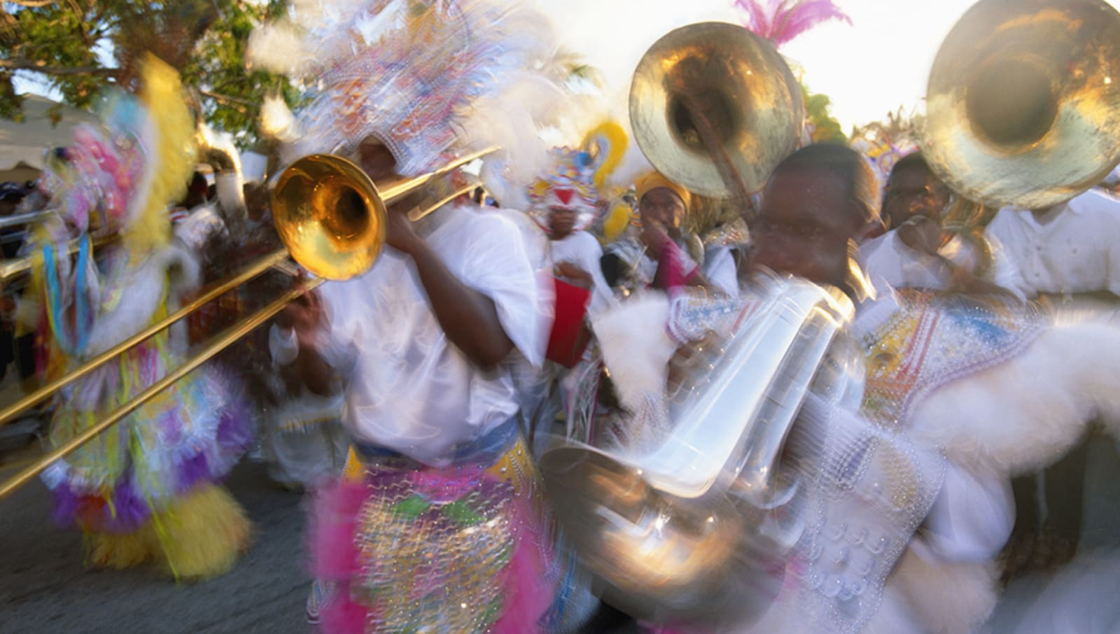 Junkanoo celebration with people playing brass instruments and celebrating