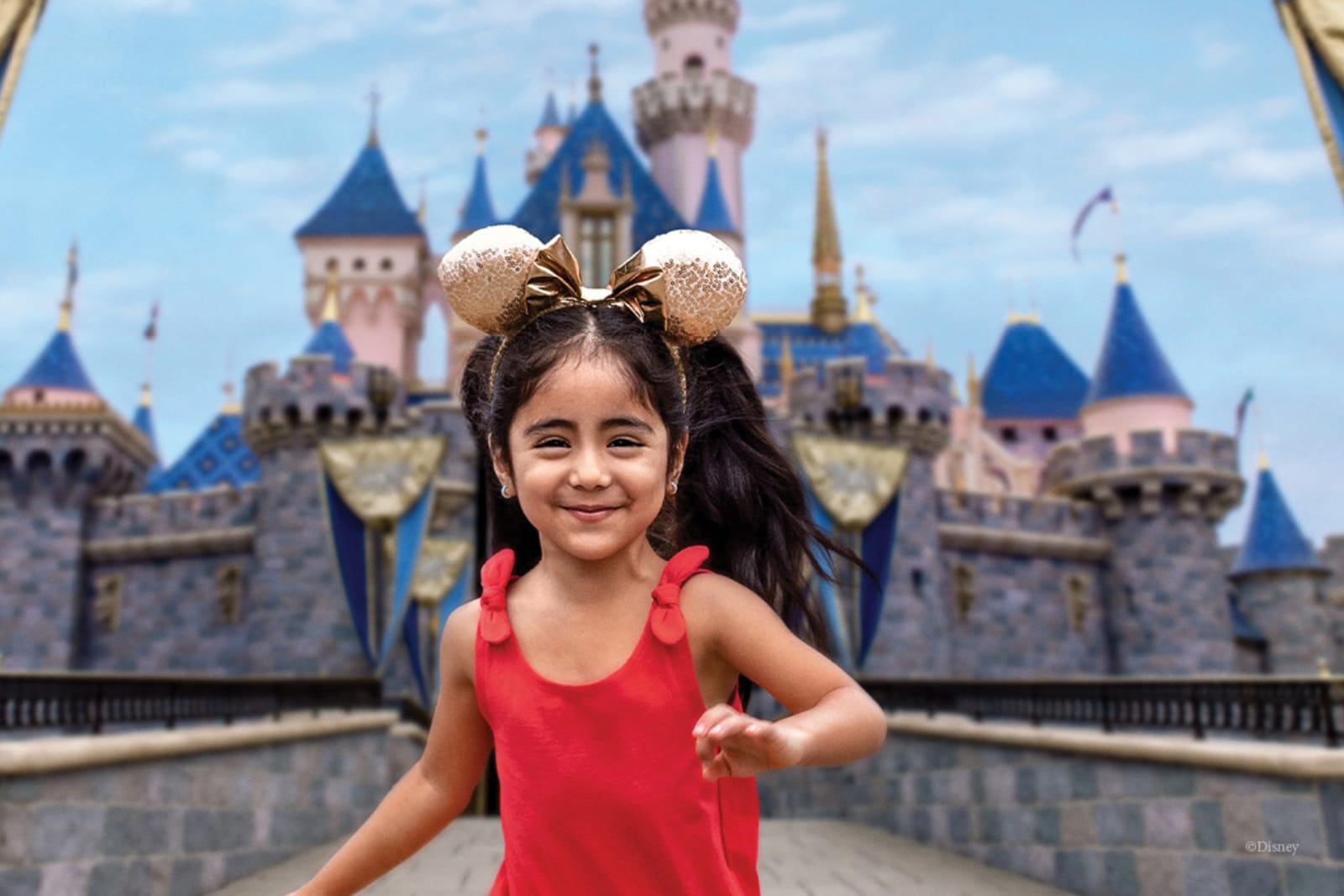 Young girl running in front of the castle at Disneyland
