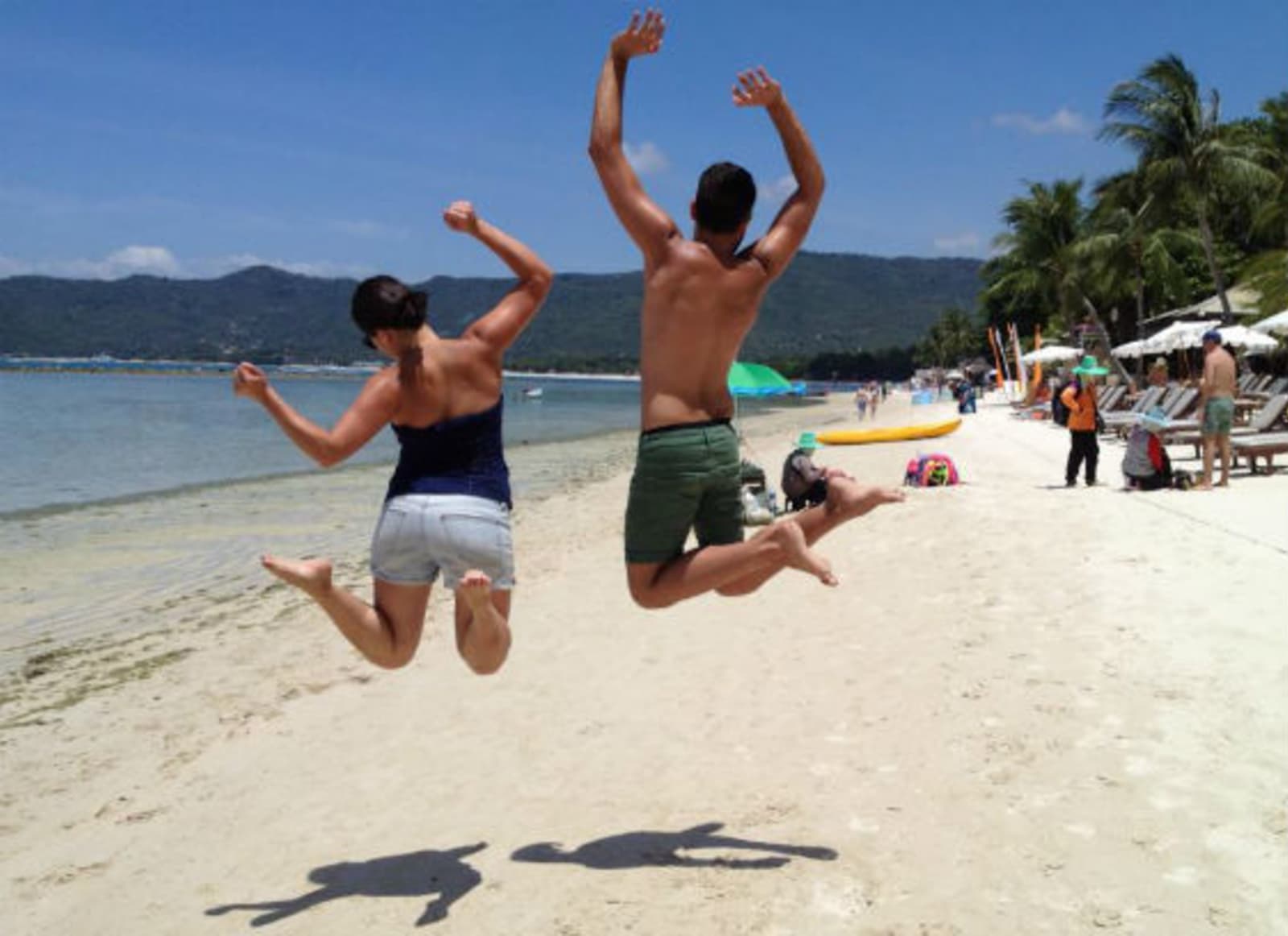 Couple jumping on the beach in Thailand