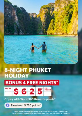 Couple holding hands wading into turquoise water beneath limestone cliffs for an 8 night Phuket holiday with 4 bonus free nights from 625 per person
