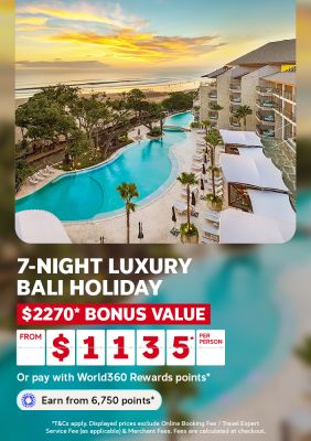 Beachfront resort pool and palm trees at sunset for a 7 night luxury Bali holiday with 2270 dollars bonus value from 1135 per person