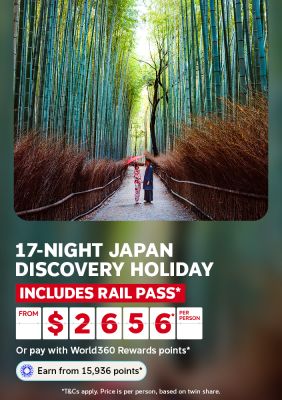 Couple sharing an umbrella in a towering bamboo grove for a 17-night Japan discovery holiday including rail pass from $2656 per person