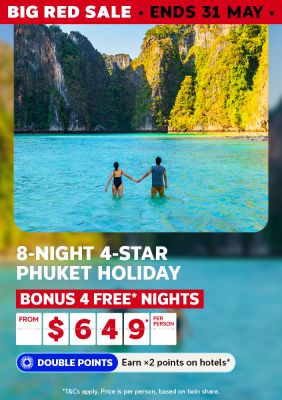 Couple wading through turquoise Phuket waters between limestone cliffs for a Big Red Sale 8-night 4-star holiday featuring bonus 4 free nights from $649