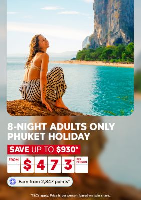 Woman relaxing on rocks beside turquoise water and limestone cliffs in Phuket for an 8-night adults only holiday saving up to $930 from $473 per person