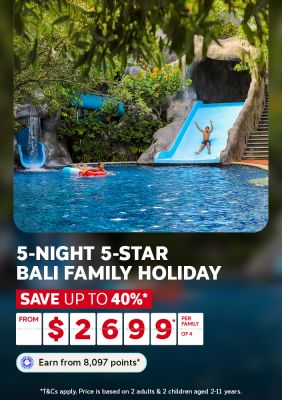 Kids sliding into a lush tropical resort pool for a 5-night 5-star Bali family holiday saving up to 40% from 2699 per family of 4