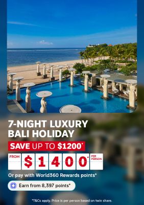 Infinity pool with statue pillars overlooking a tropical beach for a 7-night luxury Bali holiday saving up to $1200 from $1400 per person