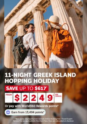 Couple holding hands walking past ancient stone columns for an 11 night Greek island hopping holiday saving up to 617 dollars from 2249 per person