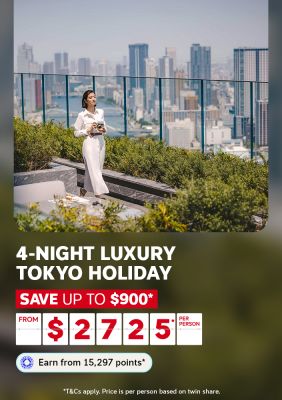 Woman with a camera admiring the Tokyo skyline from a rooftop terrace for a 4-night luxury Tokyo holiday saving up to $900 from $2725 per per