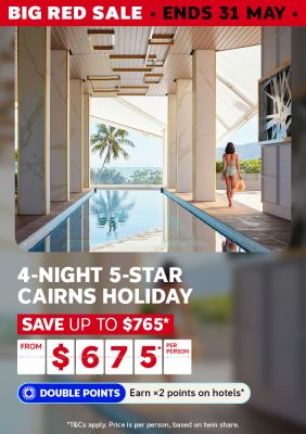 Traveller walking beside a luxury infinity pool with tropical ocean views for a 4-night 5-star Cairns holiday saving up to $765 from $675 per person