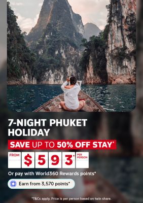 Woman sitting on a longtail boat admiring towering limestone cliffs for a 7-night Phuket holiday saving up to 50% off stay from $593 per person