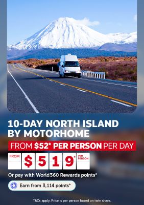 Motorhome driving toward a snow-capped volcano on a New Zealand highway for a 10-day North Island trip from $52 per person per day