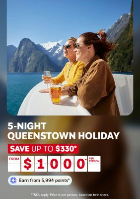 Two friends raising drinks on a boat deck overlooking Milford Sound's dramatic peaks for a 5-night Queenstown holiday saving up to $330 from $1000 per person
