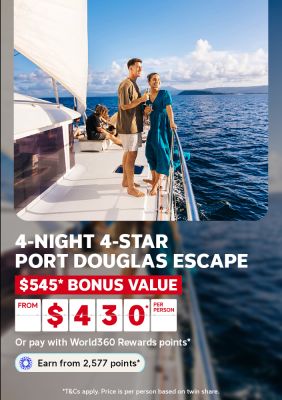 Couple enjoying champagne aboard a sailing boat at sunset for a 4-night 4-star Port Douglas escape with $545 bonus value from $430 per person