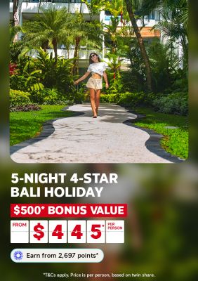Woman strolling along a winding tropical garden path at a lush Bali resort for a 5-night 4-star Bali holiday with $500 bonus value from $445 per person