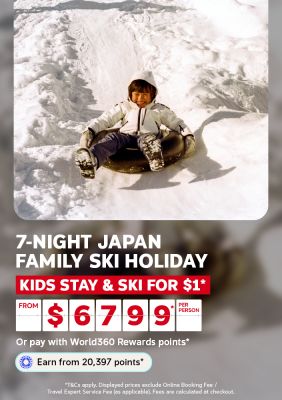 Smiling child sliding down a snowy slope on a tube for a 7-night Japan family ski holiday with kids staying and skiing for $1 from $6799 per person