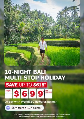 Man walking through Bali’s lush rice paddies and palm trees for a 10-night multi-stop holiday from $6999 per person, saving up to $615