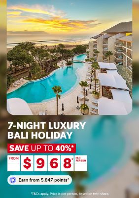 Sweeping resort pool overlooking Seminyak Beach at golden sunset for a 7-night luxury Bali holiday saving up to 40% from $968 per person
