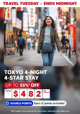 Travel Tuesday - ends midnight | Tokyo 4-night 4-stay stay. Up to 55%* off | from $482* per person - Double points. Earn x2 points on hotels* | *T&Cs apply. Price is per person, twin share. Selected travel dates only. | Woman walking through a neon-lit street in Japan
