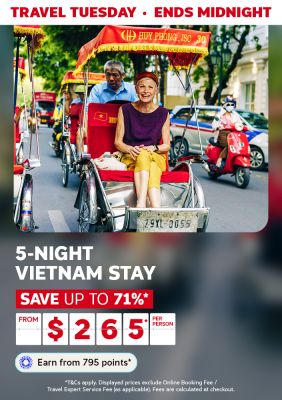 Elderly woman in a red rickshaw on a busy street featuring a 5-night Vietnam stay from $265