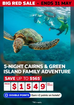 Snorkellers swimming with a sea turtle on the Great Barrier Reef for a Big Red Sale 5-night Cairns and Green Island adventure from $1549 per person