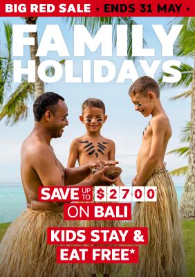 Performer sharing a coconut with face-painted children on a tropical beach for a Big Red Sale saving up to $2700 on Bali with kids stay and eat free