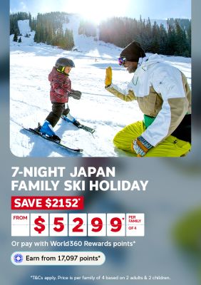 Father high fiving his son on a snowy Japanese ski slope for a 7-night family ski holiday saving $2152 from $5299 per family of 4
