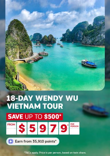 Boats sailing through the emerald limestone karst waters of Ha Long Bay for an 18-day Wendy Wu Vietnam tour saving up to $500 from $5979 per person