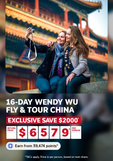 Two friends taking a selfie in front of a ornate Chinese temple for a 16-day Wendy Wu fly and tour China saving $2000 from $6579 per person