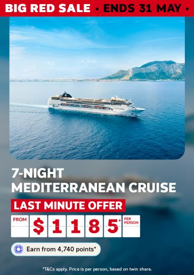 MSC cruise ship on deep blue Mediterranean waters beneath coastal mountains for a Big Red Sale 7-night cruise last minute offer from $1185 per person
