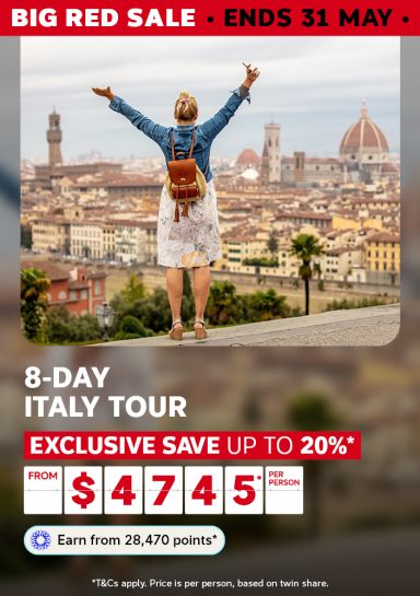 Traveller with arms raised above Florence's Duomo and terracotta rooftops for a Big Red Sale 8-day Italy tour saving up to 20% from $4745 per person