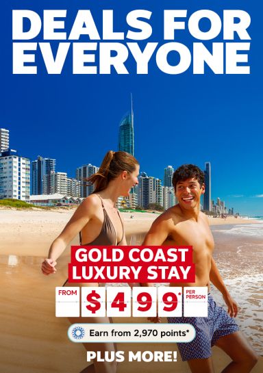 Couple holding hands, running on a Gold Coast beach featuring deals for everyone, including a luxury Gold Coast stay from $499* per person