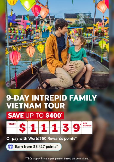 Father and son sharing a moment surrounded by colorful lanterns for a 9-day Intrepid family Vietnam tour saving up to $400 from $1139 per person